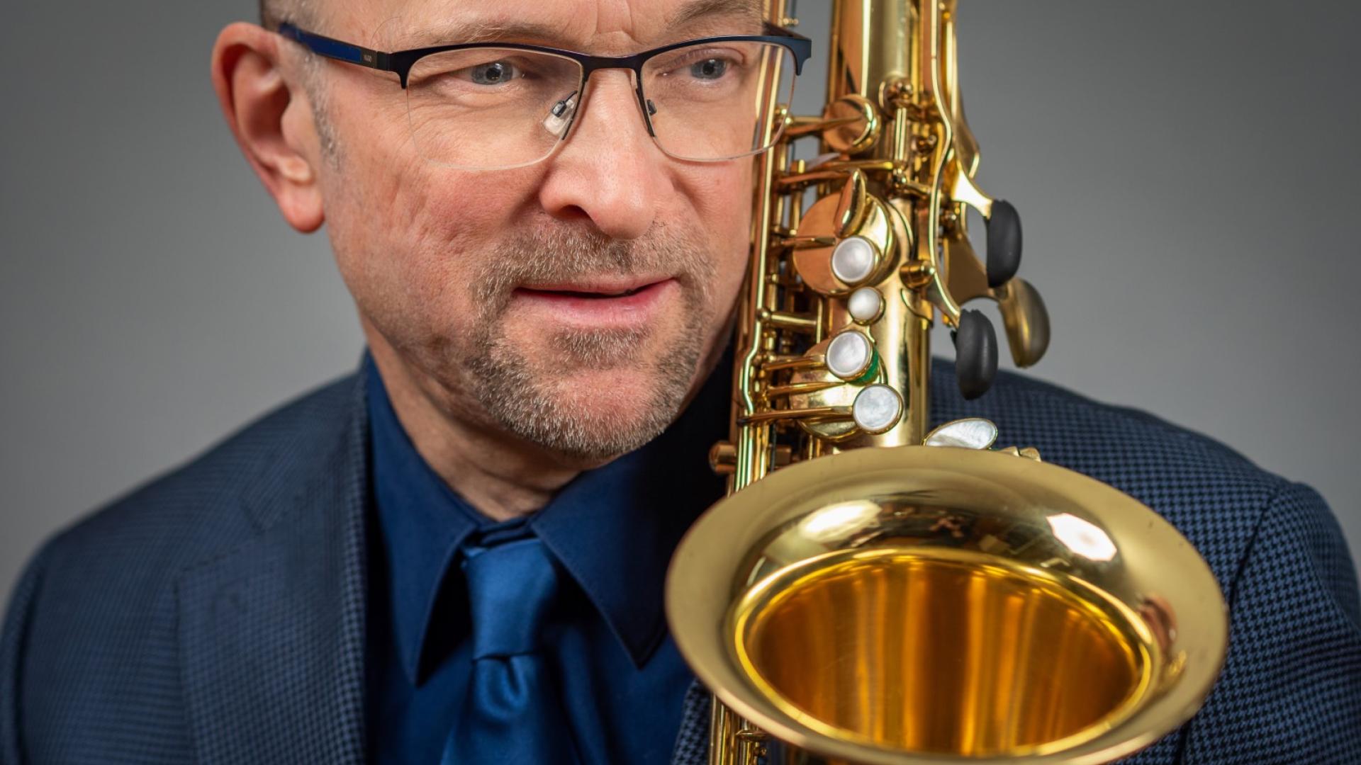 Head shot of Ernie with saxophone 