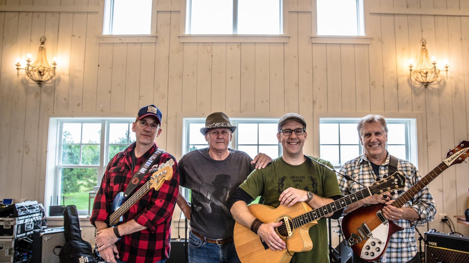 four members of the grand river band pose for the photo inside building
