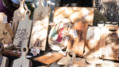 Collection of festive, custom wood carved cutting boards sold at the Christmas Market