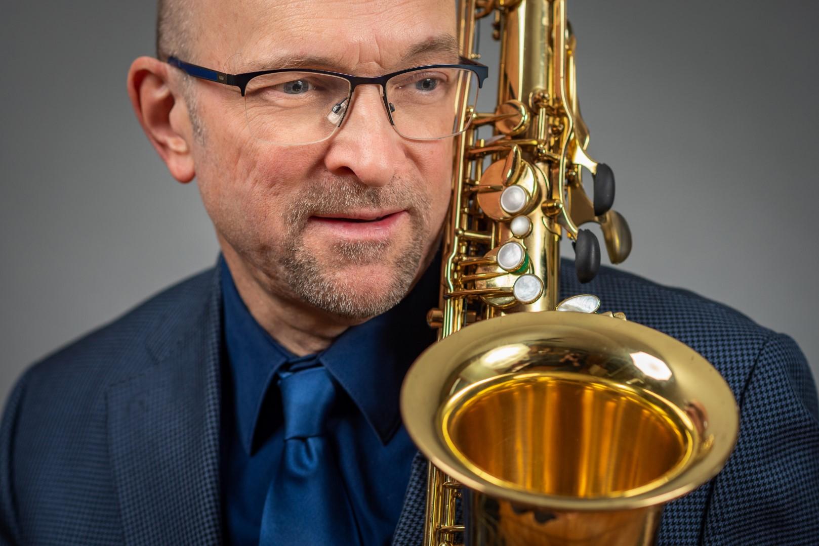 Head shot of Ernie with saxophone 